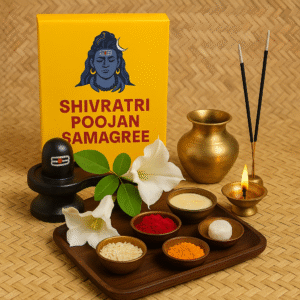"Shivratri Poojan Samagree setup with black Shivling, Bilva leaves, white flowers, brass kalash, lit oil lamp, incense sticks, and pooja items like roli, haldi, chawal, mishri, and ghee arranged neatly on a wooden tray beside a yellow box featuring Lord Shiva."