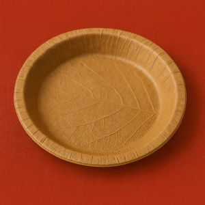 "Large disposable leaf plate (dona) with slightly bent edges, traditionally used for serving hawan samagri and prasad in Hindu rituals."