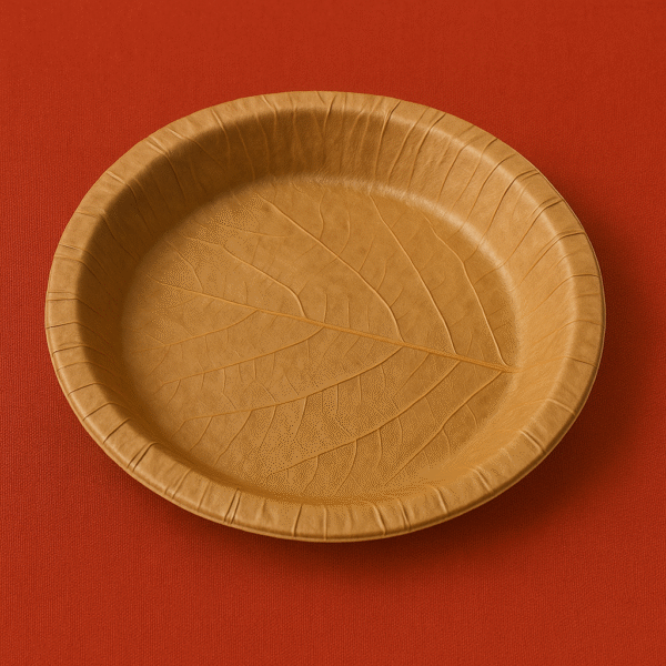 "Large disposable leaf plate (dona) with slightly bent edges, traditionally used for serving hawan samagri and prasad in Hindu rituals."